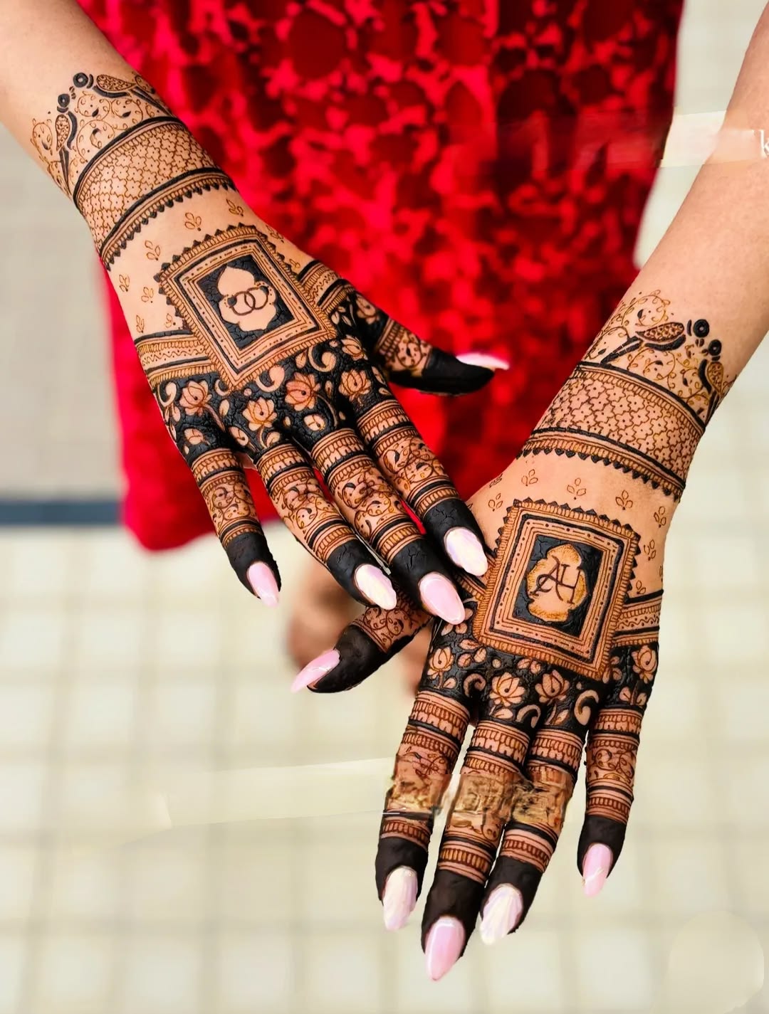 Bridal mehendi with bride and groom portrait hidden in the design