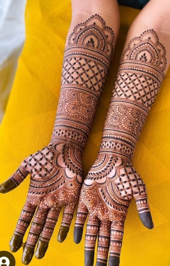 Back hand bridal mehendi design with mandala centerpiece and trailing vines 2026